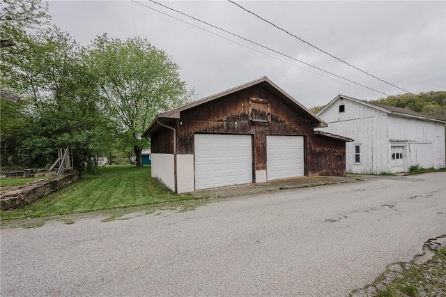 154 E Kittanning St, W/N Mahoning Twps, PA 16256 - view of home's exterior featuring a detached garage, an outdoor structure, and a yard