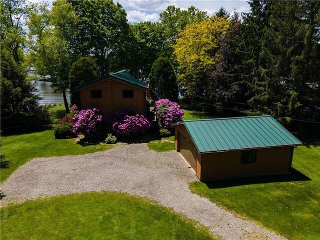 374 Latonka Dr, Jackson Twp Mer, PA 16137 - view of side of home featuring a lawn, an outdoor structure, metal roof, gravel driveway, and a standing seam roof