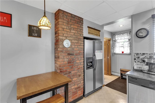 kitchen featuring appliances with stainless steel finishes, baseboard heating, a paneled ceiling, decorative light fixtures, and light tile patterned floors