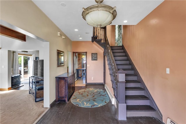 stairs with a baseboard heating unit, baseboards, hardwood / wood-style flooring, and recessed lighting