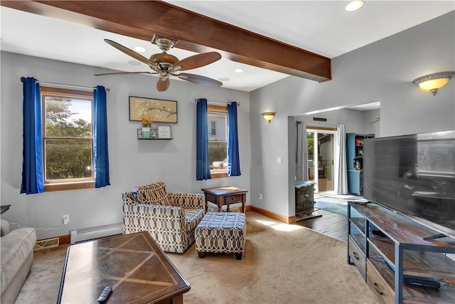 living room featuring a wood stove, baseboards, ceiling fan, a baseboard radiator, and beam ceiling