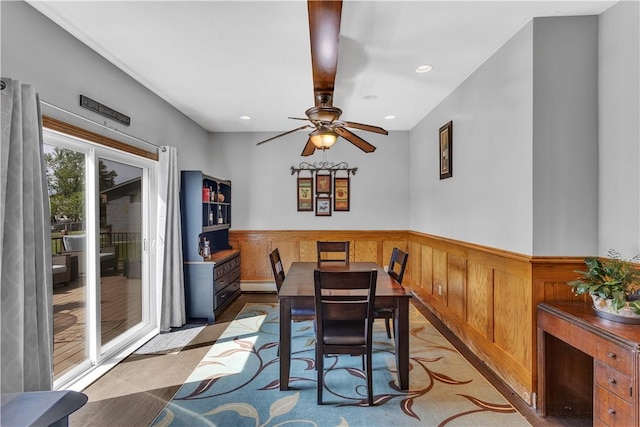 dining room with wainscoting, ceiling fan, recessed lighting, and a baseboard radiator