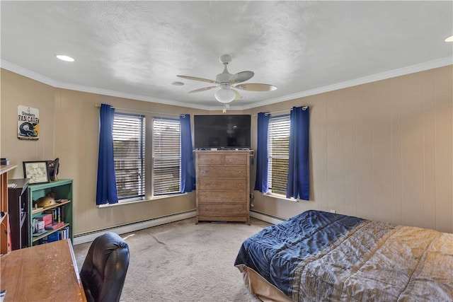 carpeted bedroom featuring a baseboard heating unit, crown molding, and a ceiling fan