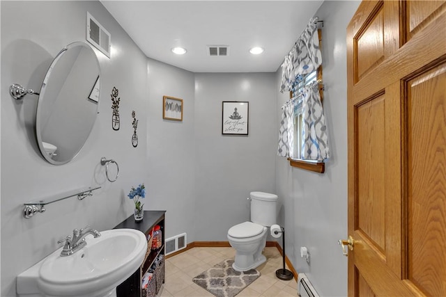 half bath with a sink, toilet, baseboards, tile patterned flooring, and recessed lighting