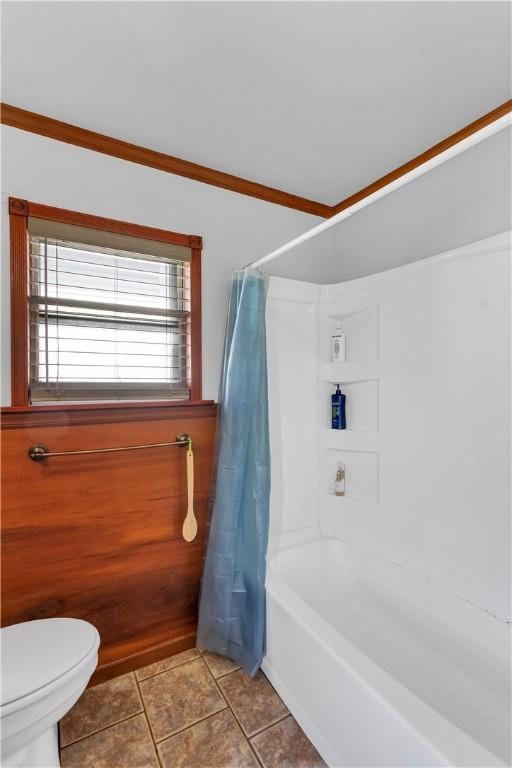 bathroom featuring toilet, tile patterned flooring, shower / tub combo, and crown molding