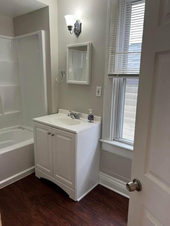 full bath featuring wood finished floors, plenty of natural light, and vanity