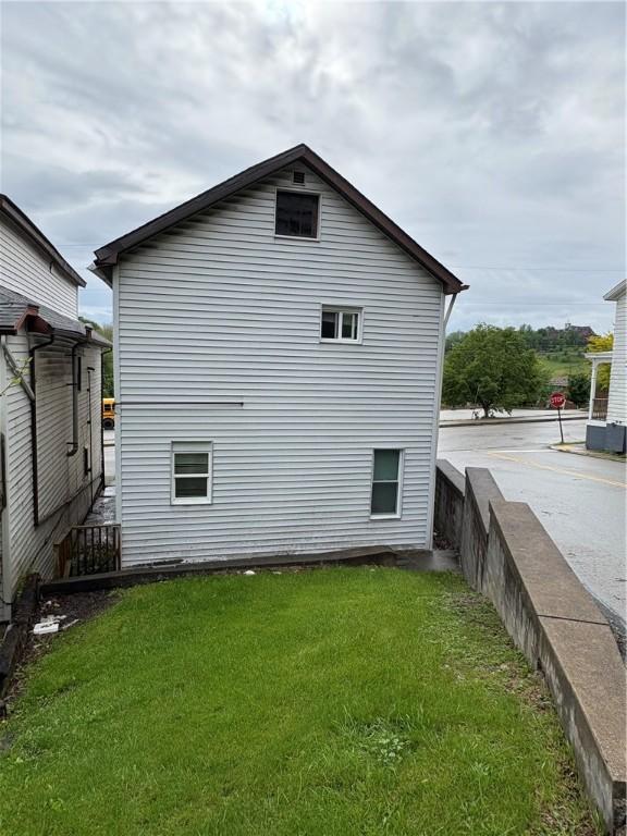 view of home's exterior with a yard