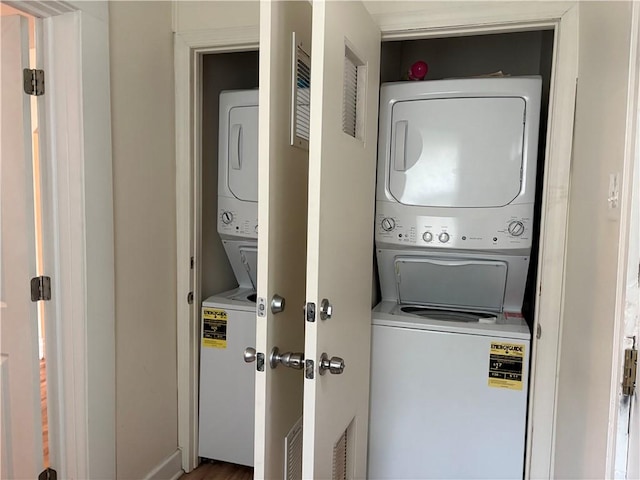 clothes washing area with stacked washer / drying machine