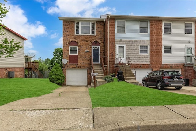 view of front of home featuring an attached garage, concrete driveway, cooling unit, and brick siding