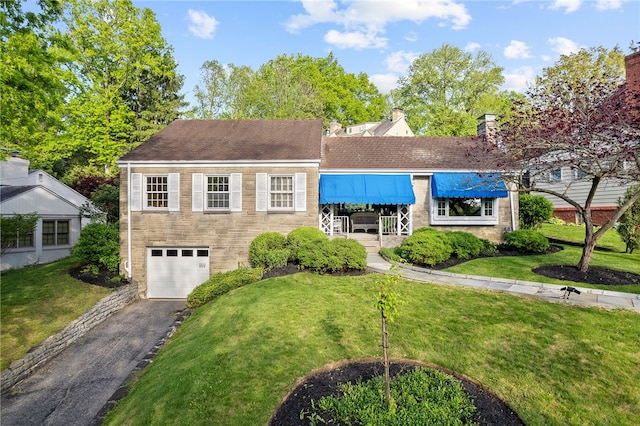 view of front facade featuring asphalt driveway, an attached garage, a front lawn, and roof with shingles