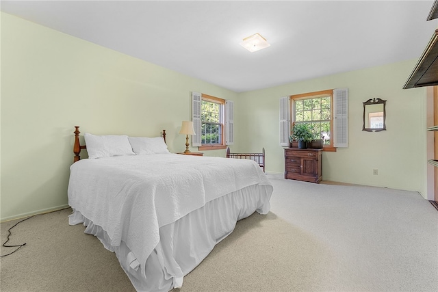 bedroom with baseboards and carpet floors