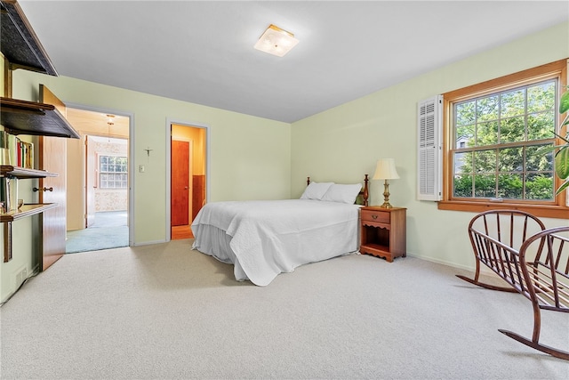 bedroom featuring carpet and baseboards