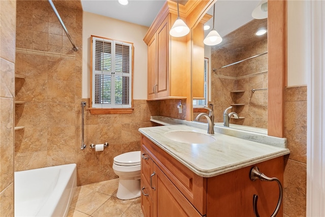 full bathroom with tile walls, tile patterned floors, toilet, vanity, and washtub / shower combination