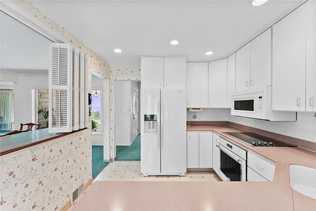 kitchen featuring white appliances, recessed lighting, white cabinets, tasteful backsplash, and light flooring