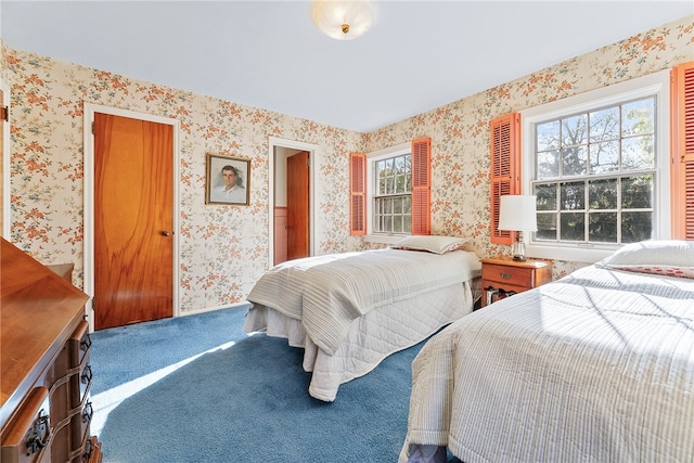 carpeted bedroom featuring wallpapered walls