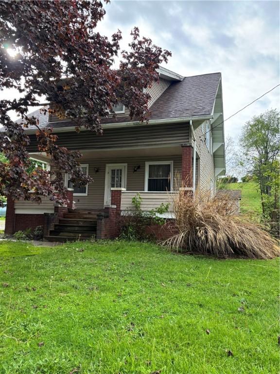view of front of house featuring a front yard and a porch