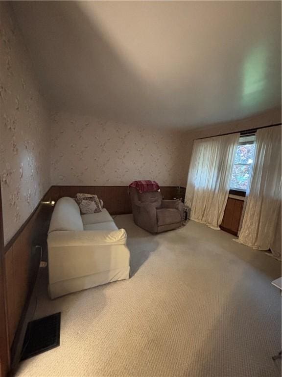 living area featuring carpet floors and wallpapered walls