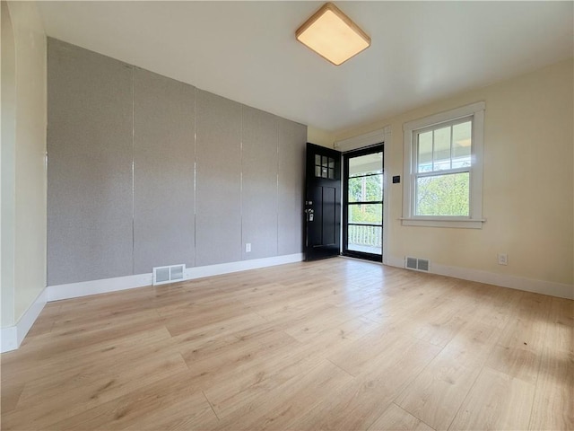 spare room with light wood finished floors and baseboards