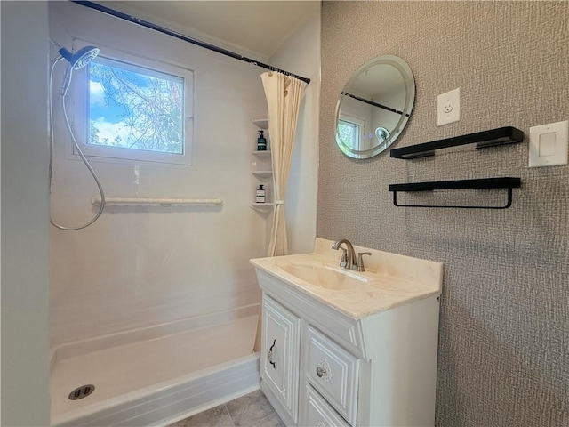 full bath featuring a shower with shower curtain, vanity, and tile patterned floors