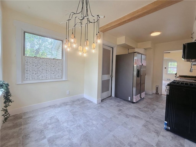 kitchen with black appliances, a chandelier, and baseboards