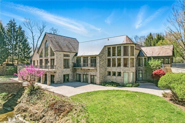 1700 Forker Blvd, Hermitage, PA 16148 - back of property featuring stone siding, a lawn, and a patio area