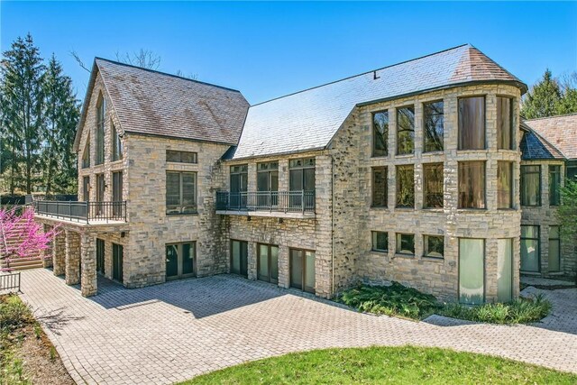 1700 Forker Blvd, Hermitage, PA 16148 - back of property featuring stone siding, a high end roof, a balcony, and a patio