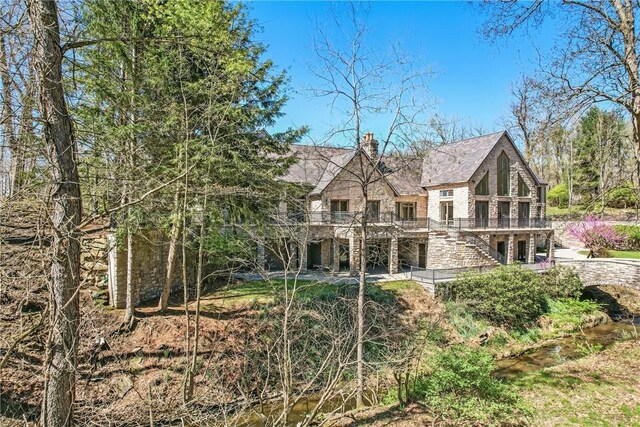 1700 Forker Blvd, Hermitage, PA 16148 - back of property with stairway, a chimney, stone siding, and a wooden deck