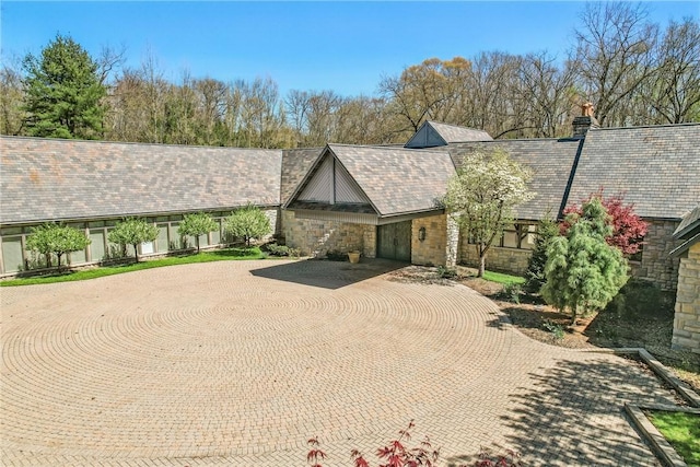 1700 Forker Blvd, Hermitage, PA 16148 - tudor home featuring stone siding, curved driveway, and a chimney
