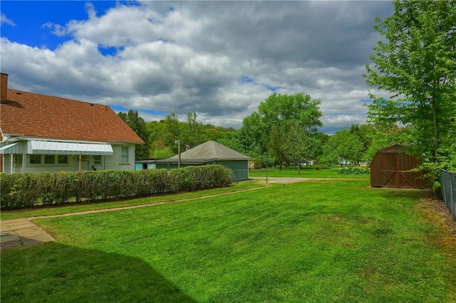 view of grassy yard with a shed and an outdoor structure