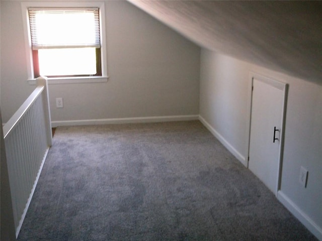 bonus room featuring carpet flooring, vaulted ceiling, and baseboards