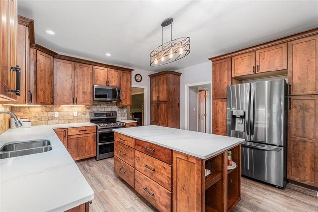 106 Briar Hill Dr, Jackson Twp But, PA 16063 - kitchen with appliances with stainless steel finishes, a sink, backsplash, a kitchen island, and light wood-style flooring
