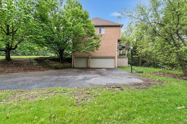 106 Briar Hill Dr, Jackson Twp But, PA 16063 - view of home's exterior featuring asphalt driveway, stairway, a garage, and a yard