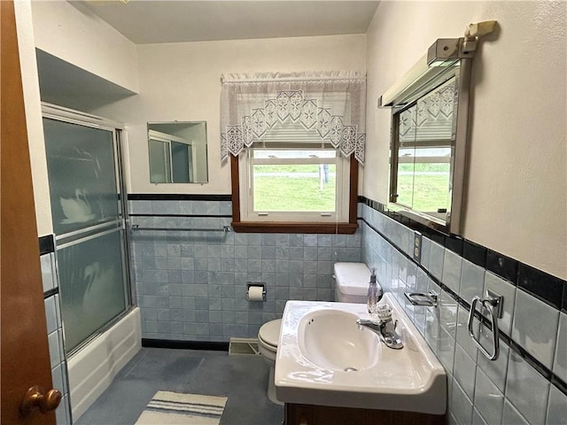 90 Dague Ln, South Franklin, PA 15301 - full bathroom with toilet, tile walls, a wainscoted wall, vanity, and shower / bath combination with glass door