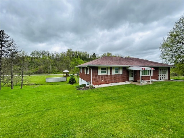 90 Dague Ln, South Franklin, PA 15301 - back of property with a yard, a garage, and brick siding