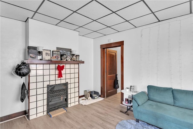 2832 Clermont Ave, Brentwood, PA 15227 - living area featuring wood finished floors, a paneled ceiling, a fireplace, and baseboards