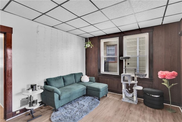 2832 Clermont Ave, Brentwood, PA 15227 - living area with a paneled ceiling, wood finished floors, and wooden walls