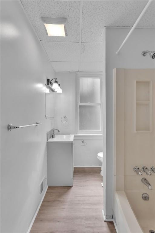 2832 Clermont Ave, Brentwood, PA 15227 - full bath featuring toilet,  shower combination, vanity, wood finished floors, and a paneled ceiling