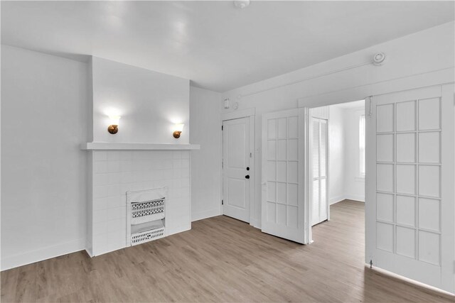 2832 Clermont Ave, Brentwood, PA 15227 - unfurnished living room with wood finished floors, baseboards, and a fireplace
