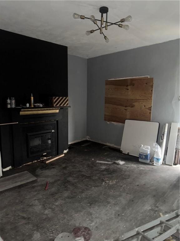 unfurnished living room with a glass covered fireplace and a chandelier