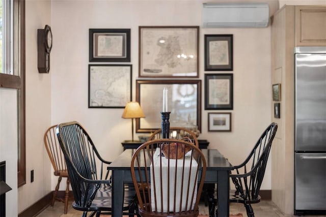 dining space featuring a wall unit AC and baseboards