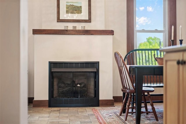 detailed view of baseboards and a fireplace