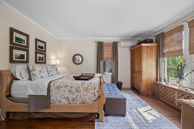 bedroom with crown molding, wood finished floors, and a wall mounted AC