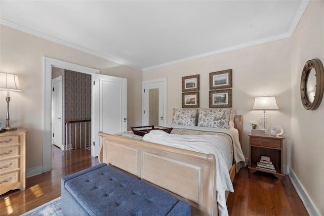 bedroom featuring wood finished floors, ornamental molding, and baseboards