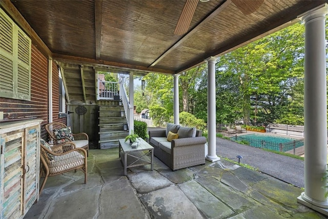 view of patio with stairs, an outdoor living space, and fence