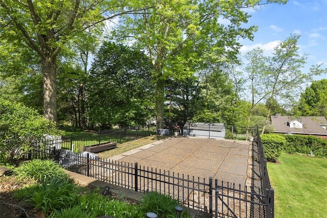 view of pool with fence and view of scattered trees