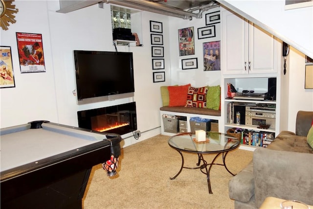 recreation room featuring carpet flooring, billiards, and a glass covered fireplace