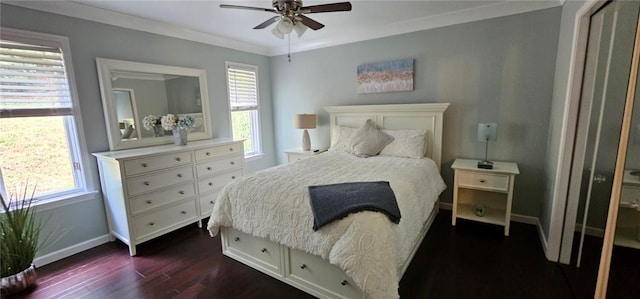 bedroom featuring dark wood-type flooring, baseboards, crown molding, and ceiling fan