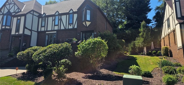 view of side of home with brick siding