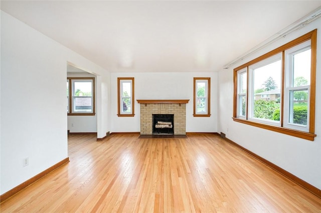 102 Olive Dr, Level Green, PA 15085 - unfurnished living room with light wood-type flooring, baseboards, and a brick fireplace
