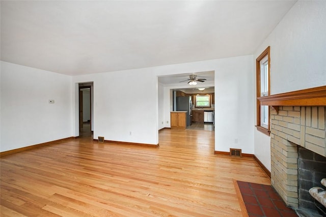 102 Olive Dr, Level Green, PA 15085 - unfurnished living room with light wood-style floors, a brick fireplace, baseboards, and a ceiling fan